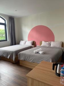 two beds sitting next to each other in a room at Kinh Đô 5 - 20 - 21 in Ðình Loan