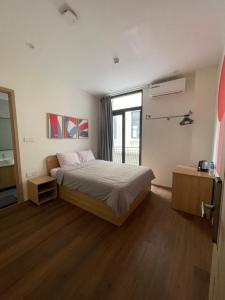 a bedroom with a bed and a large window at Kinh Đô 5 - 20 - 21 in Ðình Loan