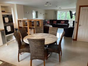 a kitchen and living room with a table and chairs at Brynhyfryd in Aberystwyth