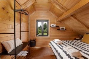 a bedroom in a log cabin with a bed at Black Cabin Lokve in Homer