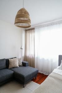 a living room with a couch and a bed at Lempi Lodge Hosted by Hygge Host in Rovaniemi +11 photos