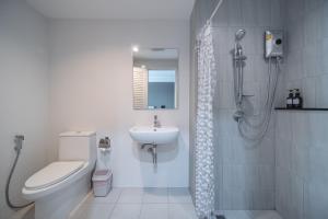 a bathroom with a shower and a toilet and a sink at Sabai Residence @Bangyai in Nonthaburi +23 photos