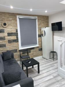 a living room with a couch and a screen at W5 Studio in Ealing