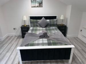 a bedroom with a bed with a bow on it at W5 Studio in Ealing