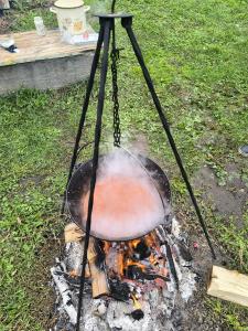 a pot on top of a fire in a grill at Casa La Casiru 17 in Straja +101 photos
