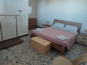 a bedroom with a bed with blue pillows at S Istentu in Sarule