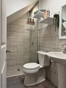 a bathroom with a toilet and a sink at Short North - Free Parking - Prime Location in Columbus