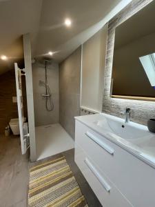 a bathroom with a white tub and a shower at RD Vosges in Ban-sur-Meurthe-Clefcy