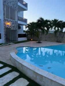 a swimming pool in front of a building at Larimar 1 Residence , Bayahibe in Bayahibe
