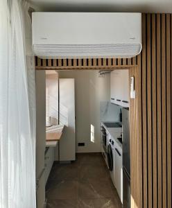 a small kitchen with a washer and dryer at LILLE`S apartment in city center in Alūksne