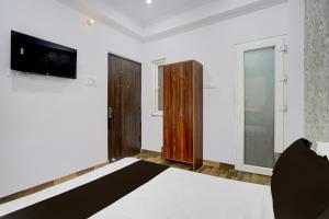 a room with a bed and a tv on the wall at HOTEL O GOLDEN MAJESTIC in Prayagraj +21 photos