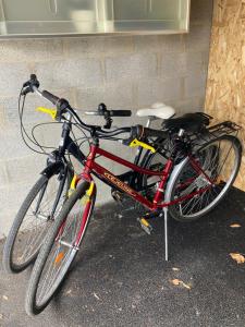 two bikes are parked next to a wall at Le GLAZ * Grande plage & commerces à pied * Jardin in Carnac