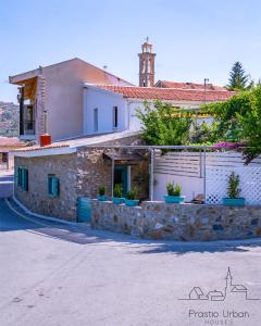 a house with a stone wall next to a street at Prastio Urban Houses  +21 photos