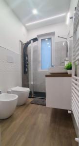 a white bathroom with two sinks and a shower at La Casetta di Frank - Country House in Chieti