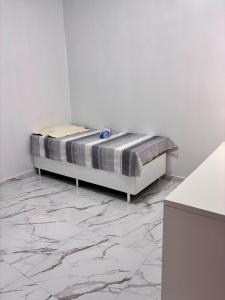 CastanhalにあるImóvel novo para COP 30-Bairro Nova Estrelaの大理石フロアの白い部屋のベッド1台分です。