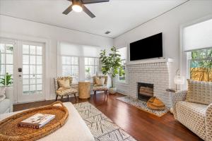 a living room with a fireplace and a tv at 2BR Bungalow Near AMI! King, W/D, Long-Stay Deals in Bradenton