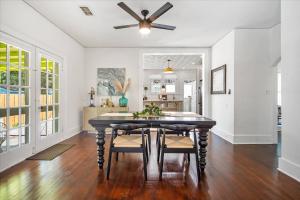 a dining room with a table and a ceiling fan at 2BR Bungalow Near AMI! King, W/D, Long-Stay Deals in Bradenton