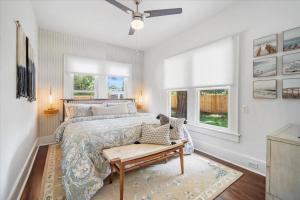 a bedroom with a bed and a table in it at 2BR Bungalow Near AMI! King, W/D, Long-Stay Deals in Bradenton