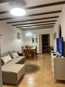 a living room with a couch and a table at Bungalow Carabassi Mediterraneo 3 Pool and roof terrace in Puerto Marino