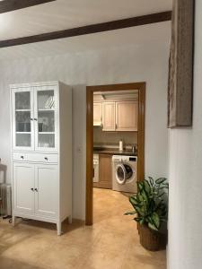 a kitchen with a white cabinet and a microwave at Bungalow Carabassi Mediterraneo 3 Pool and roof terrace in Puerto Marino