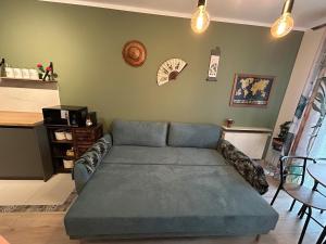 a living room with a couch and a table at Garden Spot and Parking in Krakow