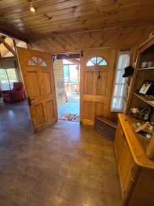 a large room with wooden doors and a room with a floor at Casa Divya in San José de Maipo +48 photos