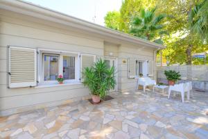 a house with windows and a patio at Hotel Sans Souci in Rimini