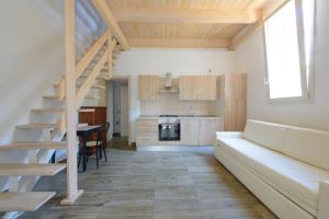 a living room with a staircase and a kitchen at Hotel Sans Souci in Rimini
