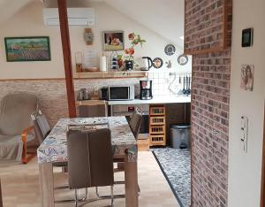 a kitchen with a dining table and a brick wall at Apartment Laurence in Hanau am Main