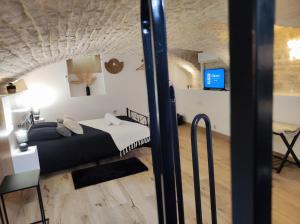 a room with a bed and a desk and a tv at Le Reflet - Vue Rivière et Caractère in Dijon