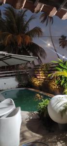 a swimming pool with palm trees in a building at CASAMAR Lucena in Lucena