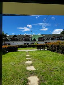 a pathway in a yard with houses in the background at Casa completa Comodidad-Ubicación Perfecta-CarmenV in Carmen de Viboral +34 photos