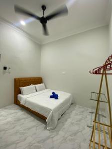 a bedroom with a bed with a ceiling fan at Nurul Ain Homestay, Kerengga Island, Marang in Marang +7 photos