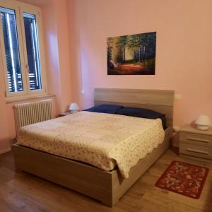 a bedroom with a bed and a painting on the wall at Wellness at home in Ancona