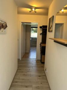 a hallway with a wooden floor in a house at Ferienwohnung Appartement am Wildpark Bad Harzburg in Bad Harzburg