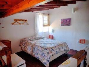 a bedroom with a bed in the corner of a room at Cabañas Megustayacanto in Villa Yacanto