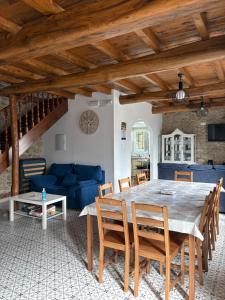 a dining room with a table and a blue couch at Casa De Don Lino in Lugo