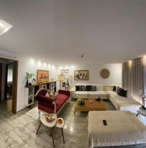 a living room with a couch and a table at Fort View Apartment in Kelibia