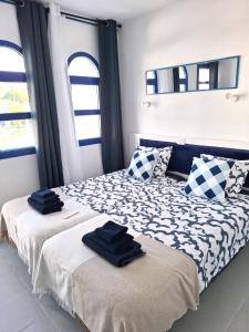 a bedroom with two beds with towels on them at Casa Romantico - Playmar - Maspalomas in Maspalomas +41 photos