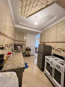 a kitchen with a stove and a counter top at A nice appartement a louer temara in Temara