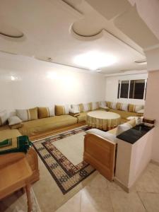 a living room with a couch and a table at A nice appartement a louer temara in Temara