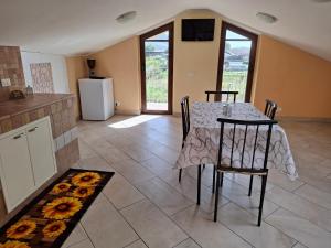 a kitchen and dining room with a table and chairs at La mansarda di Iside in Fondi