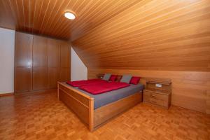 a bed in a room with a wooden ceiling at Ferienwohnung Moselblick Zell-Merl - Merllorca DG Panoramablick & Parkplatz in Zell an der Mosel