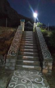 a set of stairs with a light at night at Captain's House in Kalymnos