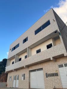 a building with two garage doors in front of it at Caribbei Apartamentos de Hospedagem in Maragogi +15 photos
