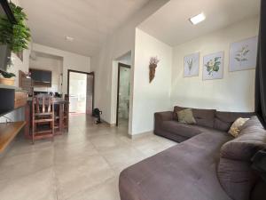 a living room with a couch and a table at Apartamento mobiliado com Wi-Fi in Sinop