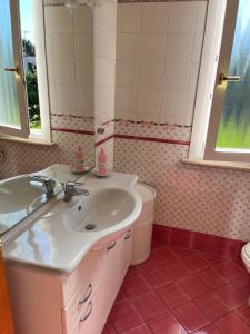 a bathroom with a sink and a toilet at Oasi Blu in Marina di Pietrasanta +60 photos