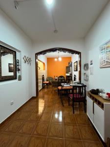 a living room with a table and a dining room at Casa BB&Djassi - ROOMS in Ponta do Sol