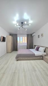 Ένα ή περισσότερα κρεβάτια σε δωμάτιο στο Мангилик Ел 10