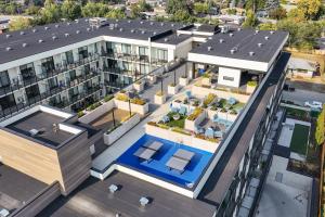 an overhead view of a building with a pool at Central Kelowna TOP FLOOR rooftop patio in Kelowna